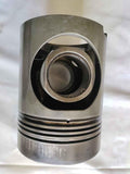 A high-quality Yanmar M200 piston for marine engines, featuring piston rings and a pin hole.